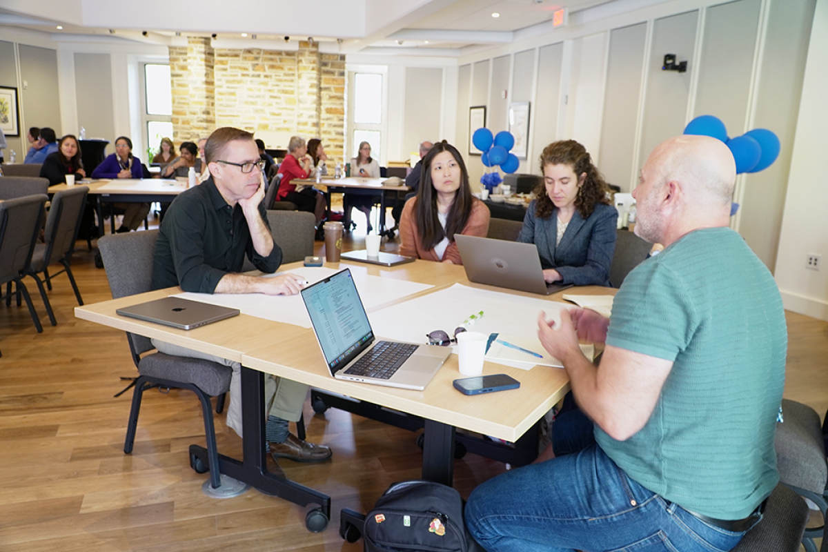 Adults discuss AI during Duke workshop.