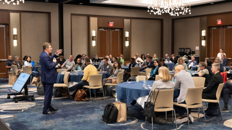 President Price speaking to fellows as they listen