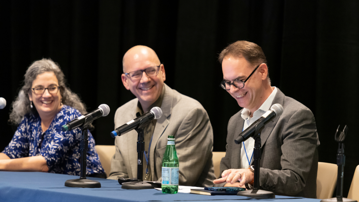 Three faculty members serving on the panel.